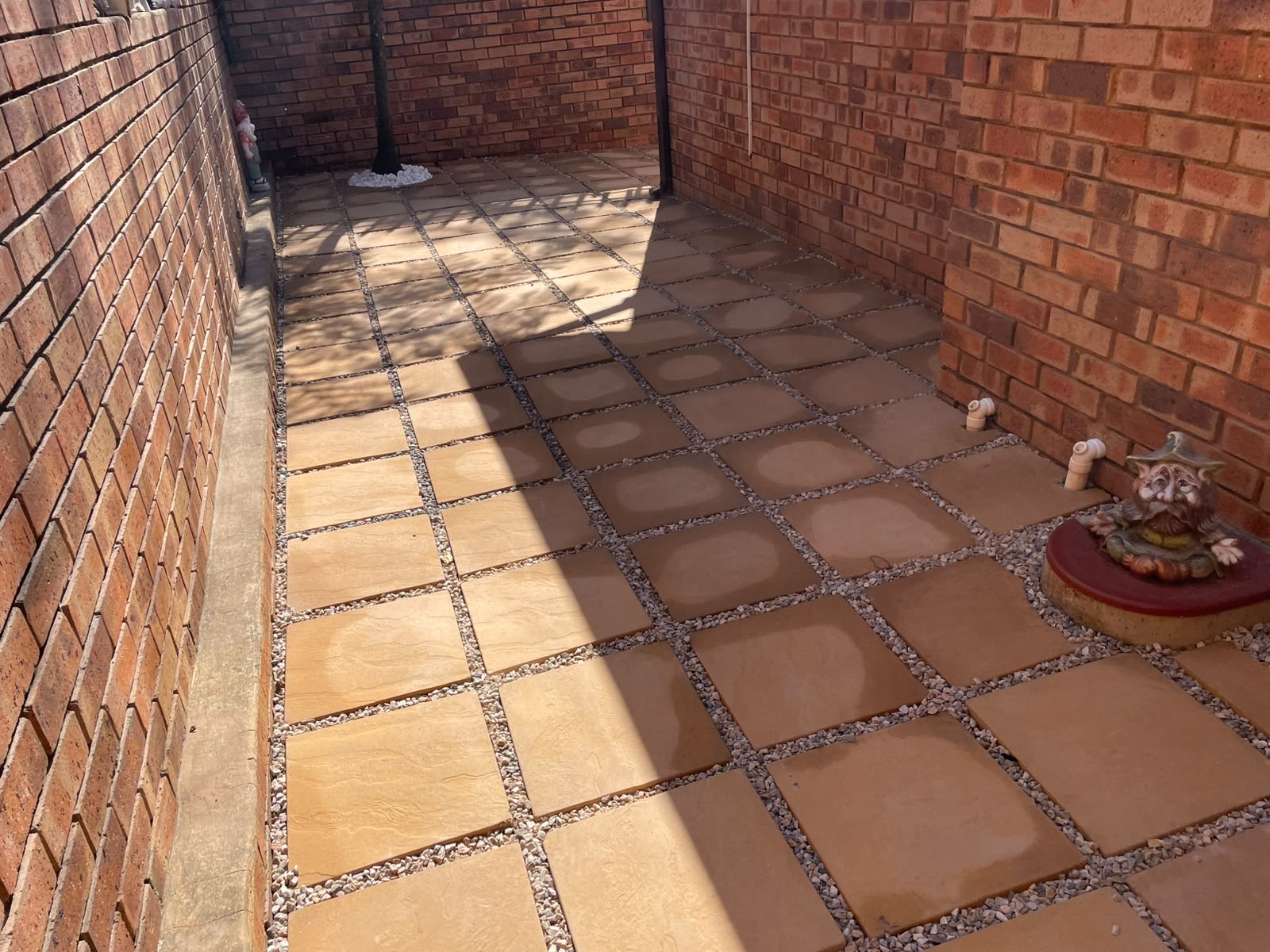Half-finished job to fully tiled, gravel-jointed patio — after