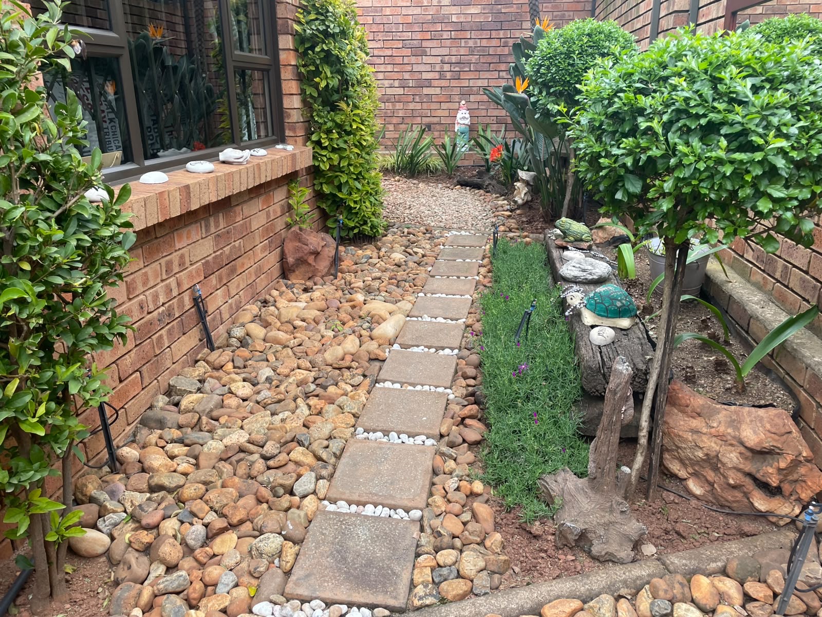 Half-finished job to fully tiled, gravel-jointed patio — before