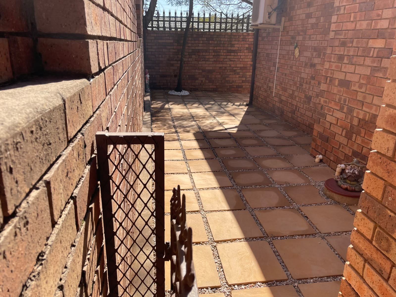 Neglected corner reborn as a tiled courtyard — after